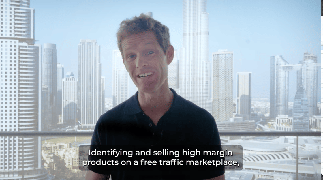 Aidan Booth stands in front of a city scape background. The words 'Identifying and selling high margin products on a free traffic marketplace' are captioned.